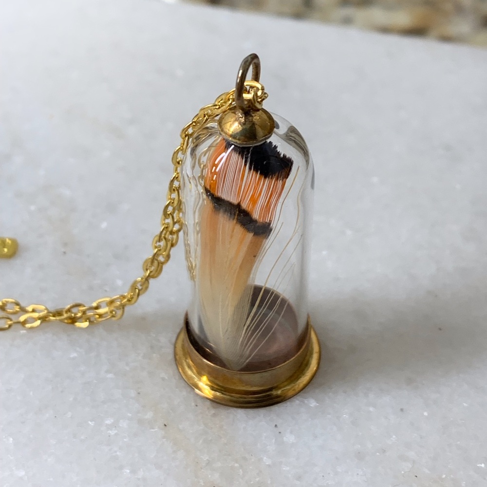 Miniature cloche with feather necklace